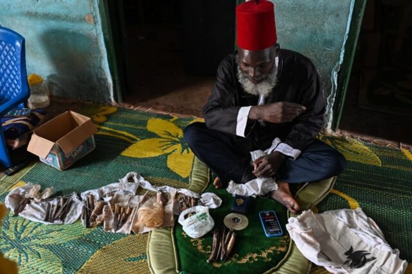 Mory Bamba, a Muslim leader who fights FGM in Ivory Coast, with some of the blades used to