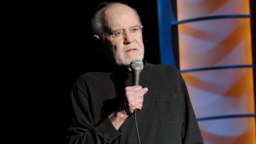 George Carlin with microphone