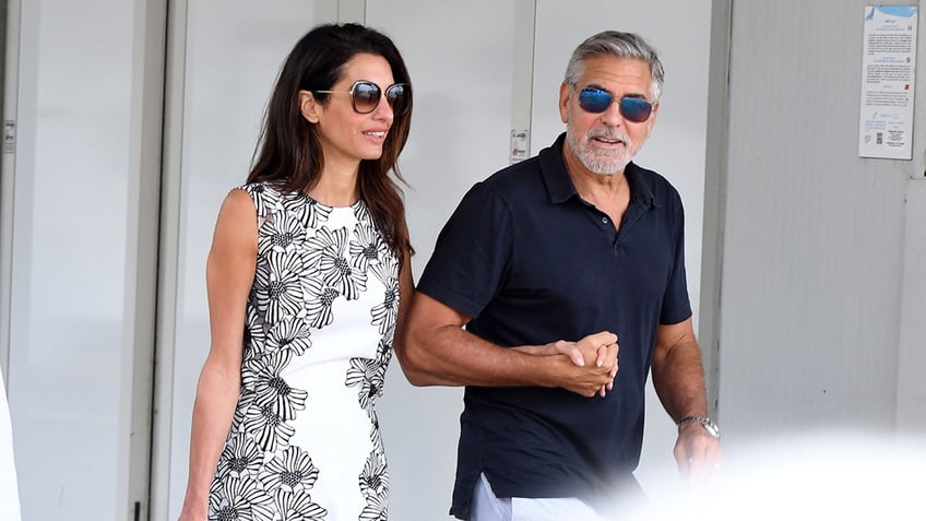 george clooney plays leading man to wife amal in venice as she receives major honor