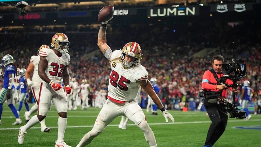 George Kittle spikes the ball