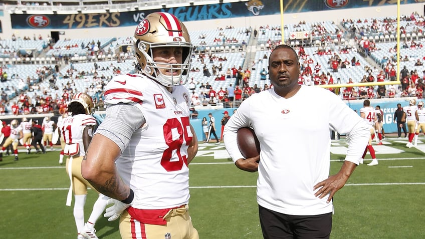 George Kittle and Jon Embree on field