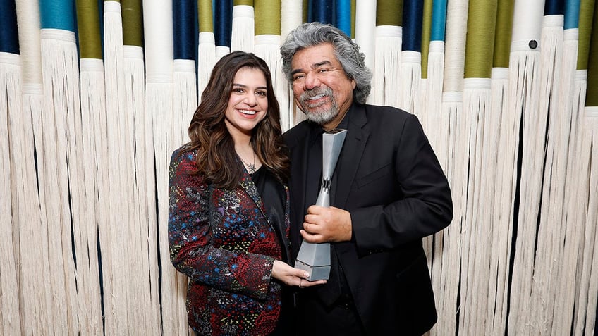 Mayan Lopez and George Lopez posing together
