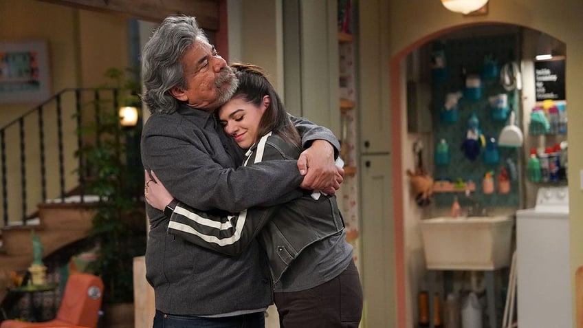 George Lopez hugging Mayan Lopez on the set of their sitcom