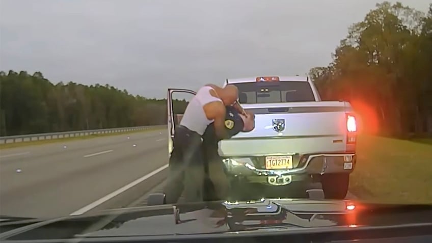 Police dash camera video shows a traffic stop involving a sheriff's deputy and Leonard Cure.