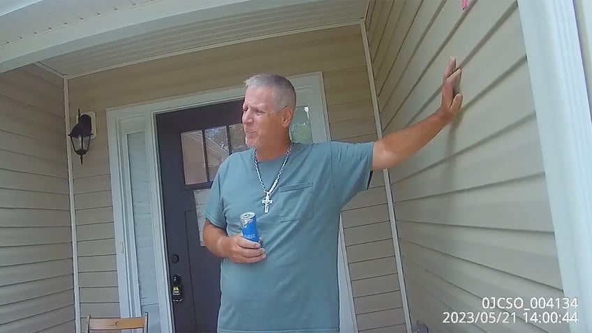 Colin Gray speaks outside his home