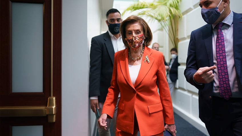 Speaker of the House Nancy Pelosi, D-Calif., arrives to meet with the Democratic Caucus at the Capitol in Washington, early Tuesday, Nov. 2, 2021. 
