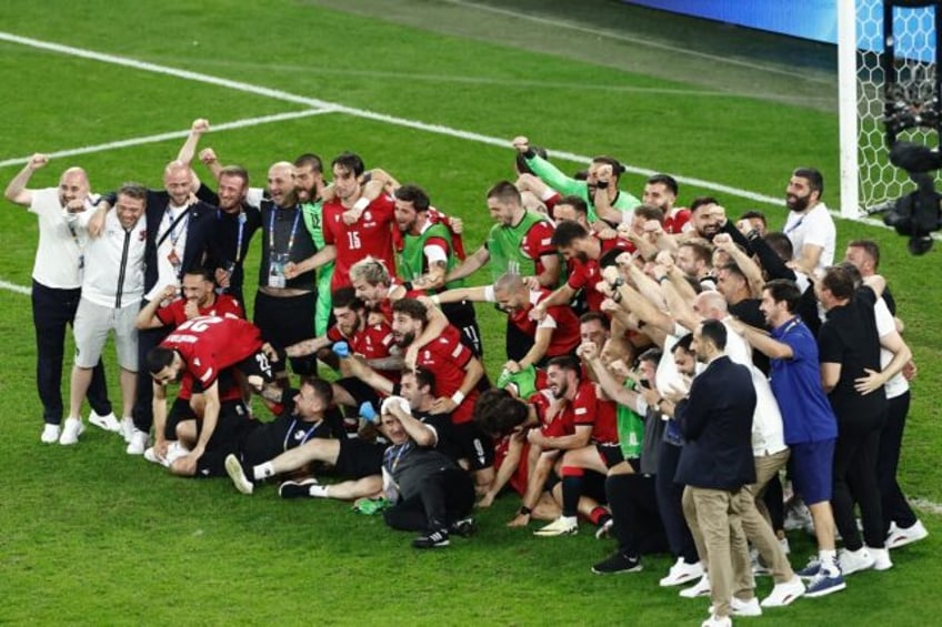 Georgia players celebrate on the Gelsenkirchen pitch after beating Portugal to qualify for