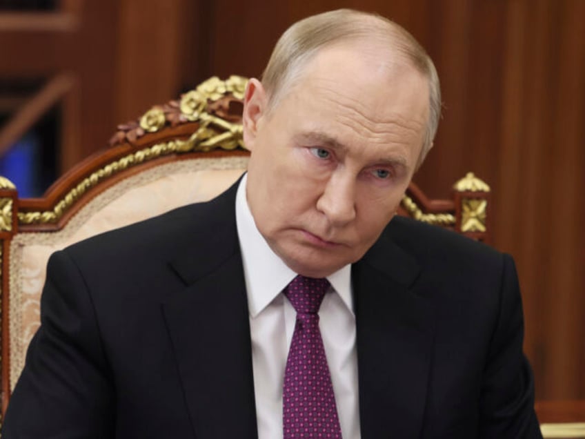 Russian President Vladimir Putin listens to the leader of the Liberal-Democratic Party of