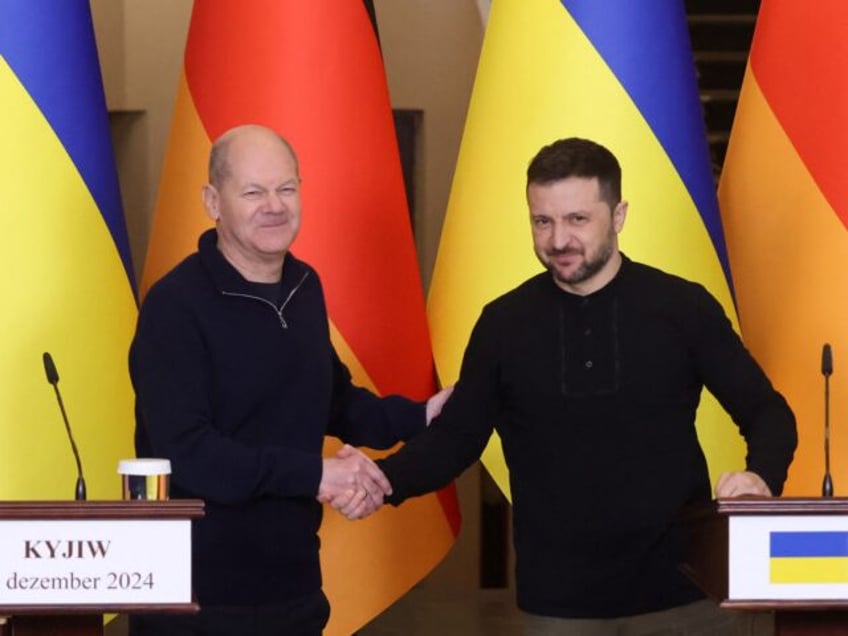 German Chancellor Olaf Scholz (L) and Ukrainian President Volodymyr Zelensky (R) shake han