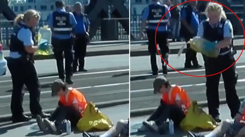 german driver erupts in anger as he slaps and grabs radical climate protester blocking road in berlin