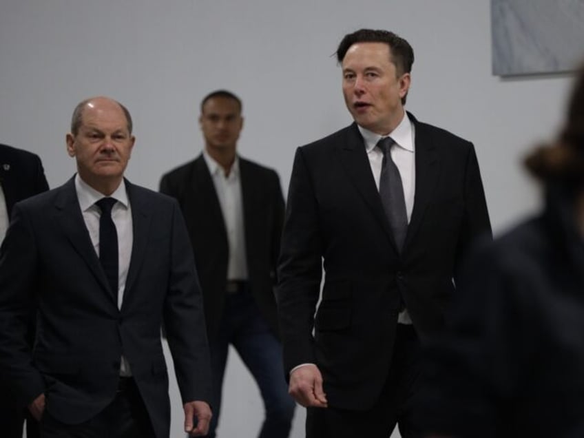 GRUENHEIDE, GERMANY - MARCH 22: Tesla CEO Elon Musk and German Chancellor Olaf Scholz duri