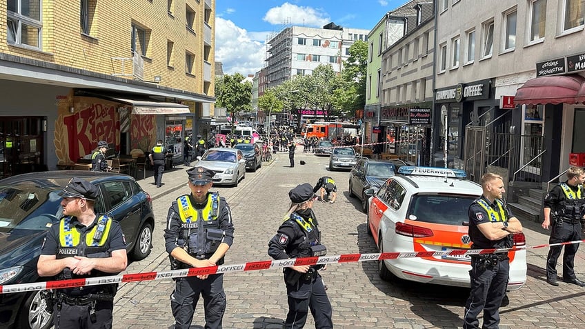 German police stand guard after shooting an ax-wielding suspect 