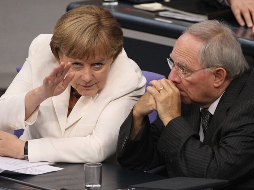 BERLIN, GERMANY - JUNE 29: German Chancellor Angela Merkel chats with Finance Minister Wolfgang Schaeuble during debates pior to a vote in the Bundestag on Germany's ratification of the European Stability Mechanism (ESM) and the European Union fiscal pact on June 29, 2012 in Berlin, Germany. The two measures together …