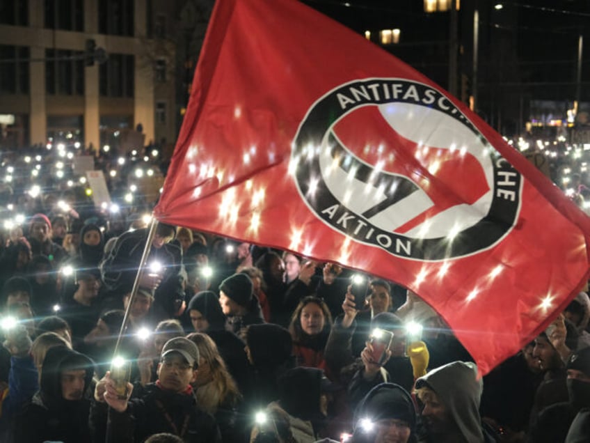21 January 2024, Saxony, Leipzig: Participants in a rally gather on Johannisplatz and light up their phones with flashlights. Participants in a rally gather on Johannisplatz while pyrotechnics are set off. According to initial police reports, more than ten thousand people gathered in Leipzig on Sunday for a demonstration against …