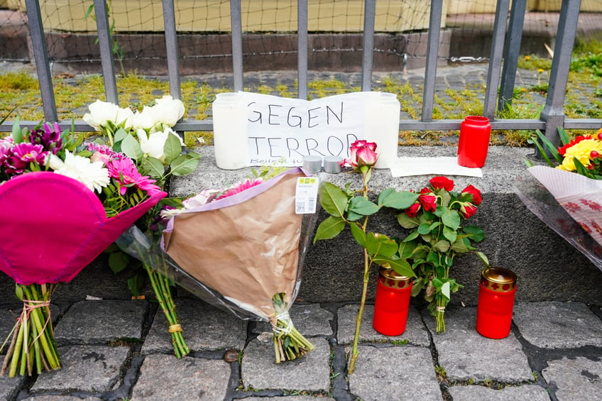 01 June 2024, Baden-Württemberg, Mannheim: Candles, flowers and a piece of paper with the inscription "Against Terror" stand at the scene of the crime on the market square. The perpetrator had attacked participants at an anti-Islamic rally on Mannheim's market square on Friday morning and injured six people, including a police officer. Photo: Uwe Anspach/dpa (Photo by Uwe Anspach/picture alliance via Getty Images)