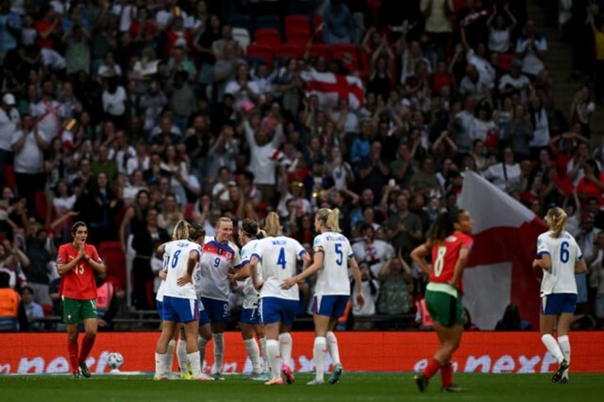 Aggie Beever-Jones (number 9) is mobbed by her England teammates after completing her Wemb