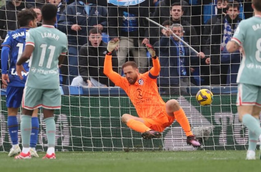 Atletico goalkeeper Jan Oblak reacts after being beaten by Getafe's second goal in their c