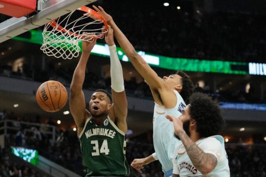 Milwaukee's Giannis Antetokounmpo, at left dunking over San Antonio's Victor Wembanyama, r