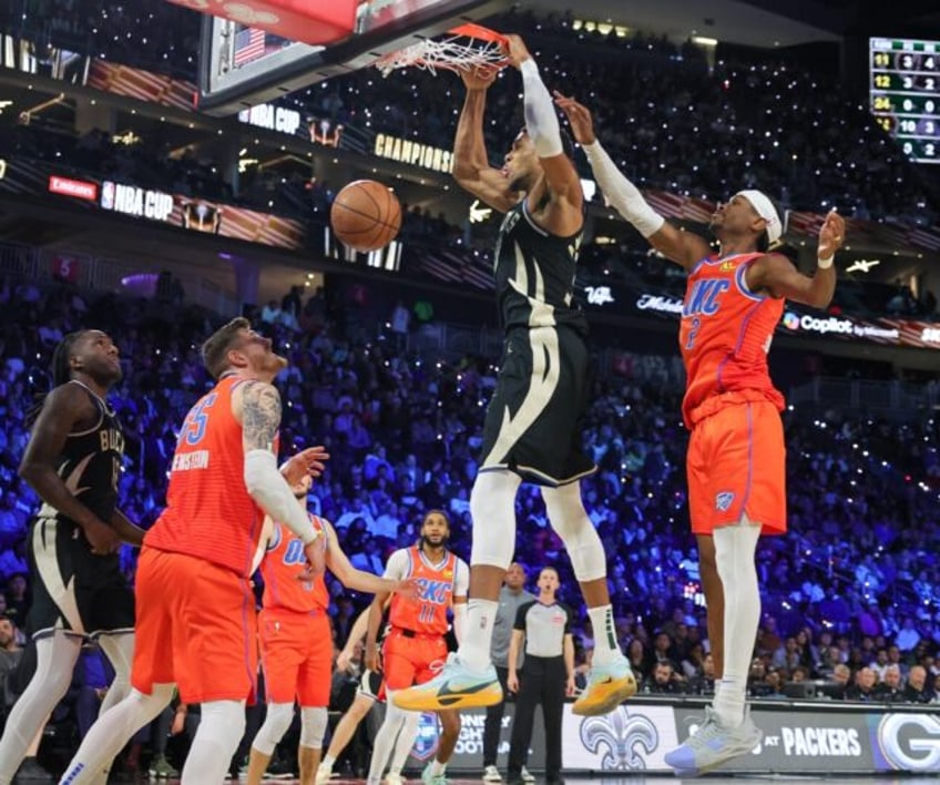 Giannis Antetokounmpo of the Milwaukee Bucks throws down a dunk over Shai Gilgeous-Alexand