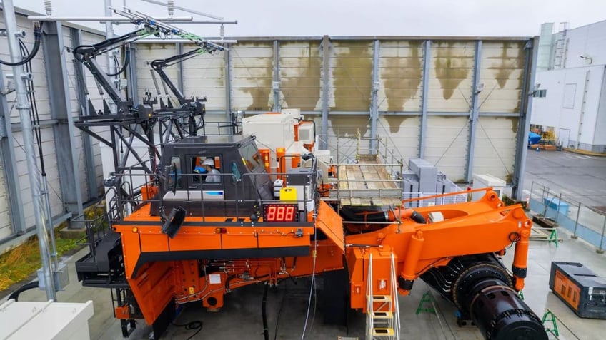 Giant battery-powered dump truck dumps diesel for electric