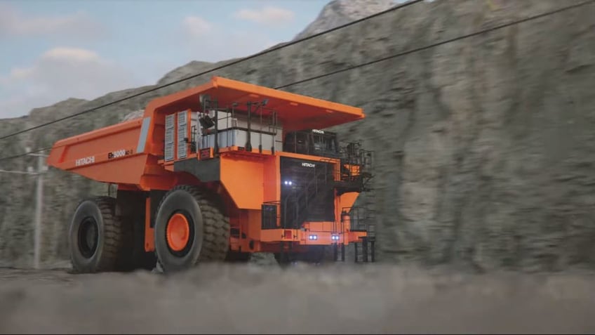 Giant battery-powered dump truck dumps diesel for electric