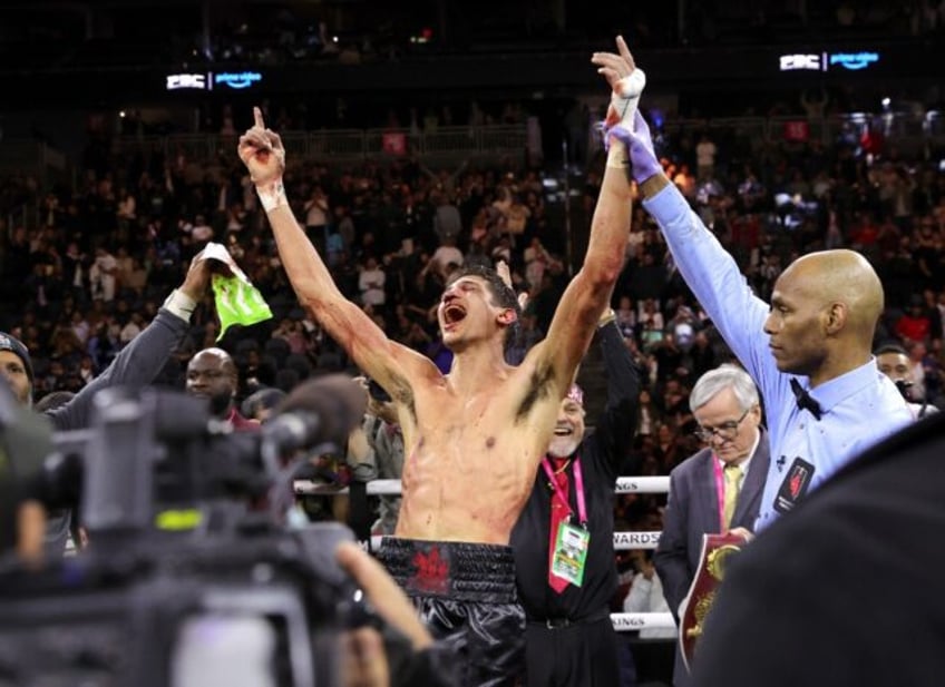 American Sebastian Fundora raises his arms in victory as his hand is raised by referee Har