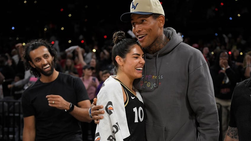 Darren Waller embraces his wife Kelsey Plum