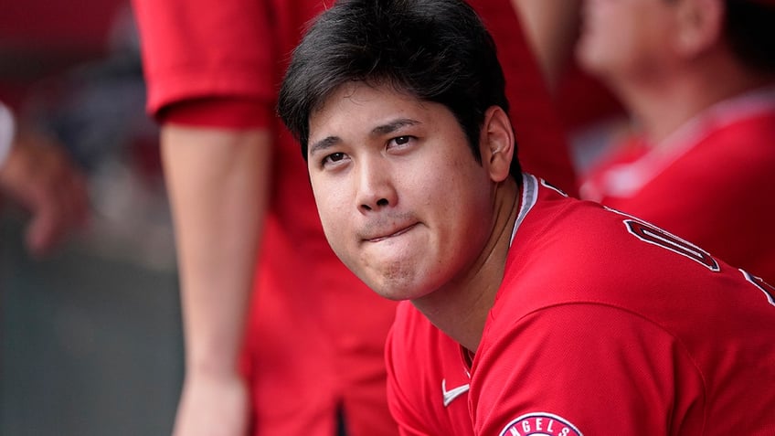 Shohei Ohtani sits on the bench