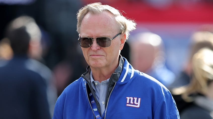 John Mara looks on