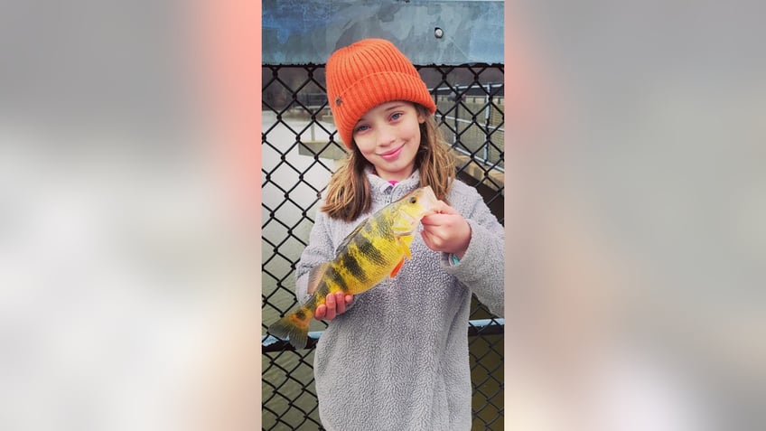 Lucy-holding-yellow-fish