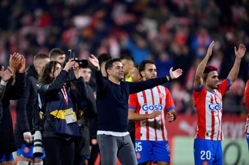 Girona's Spanish coach Michel (C) celebrates victory at the end of the thrilling 4-3 win over Atletico Madrid