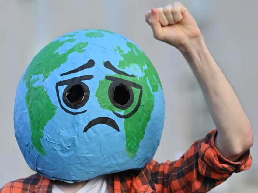 CARDIFF, WALES - NOVEMBER 06: A man wears a papier mache sad planet on his head on Novembe