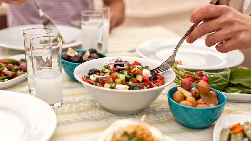 Eating Lunch with Fresh Salad and mediterranean Appetizers