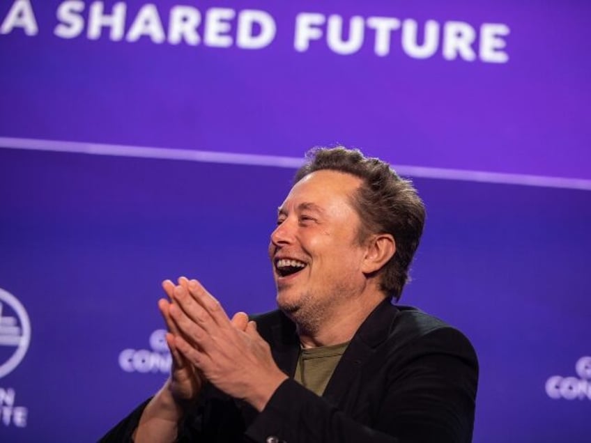 Elon Musk laughing on stage