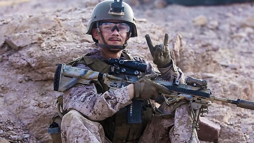 Kareem Nikoui posing with a gun