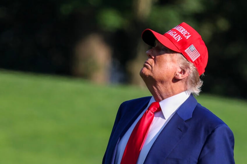 WASHINGTON, DC - JUNE 21: U.S. President Donald Trump looks up at the new flag on the sout