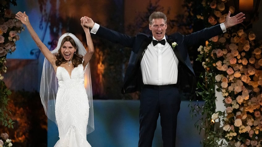 Theresa Nist and Gerry Turner hold hands after marriage