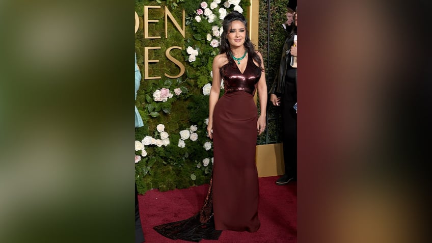 Salma Hayek wore a red dress with a plunging neckline to the 2025 Golden Globe Awards.