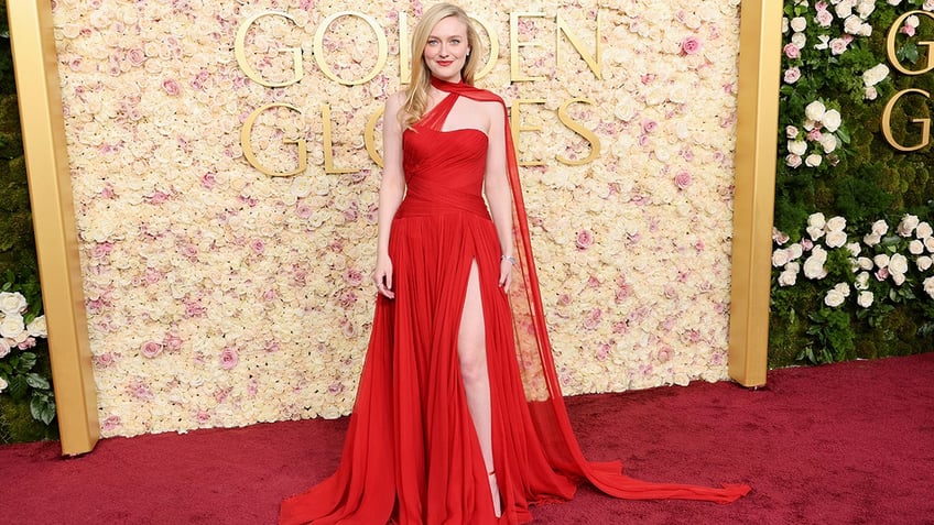 Dakota Fanning walked the red carpet at the 2025 Golden Globe Awards in a red dress with a thigh high slit.