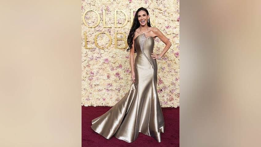 Demi Moore wore a figure-hugging strapless gold gown on the 2025 Golden Globe Awards red carpet.