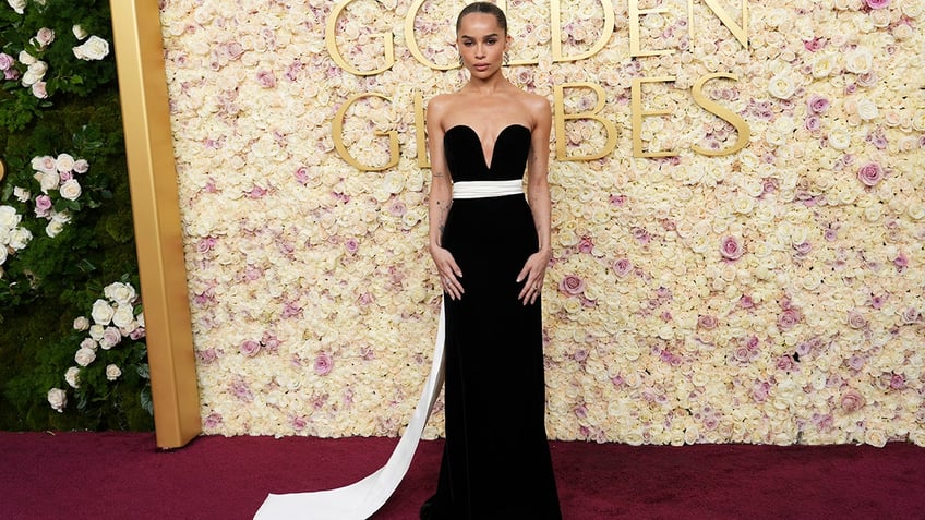 Zoe Kravitz walked the red carpet at the 2025 Golden Globe Awards in a strapless black dress with a pink train.