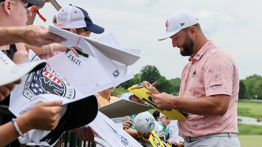 Jon Rahm signs autographs