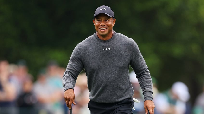 Tiger Woods smiles on course