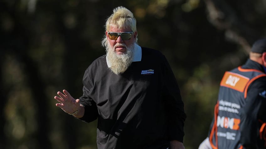 John Daly looks on