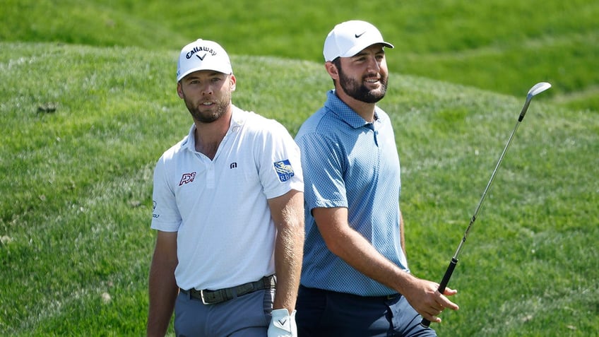 Sam Burns and Scottie Scheffler stand on the golf course