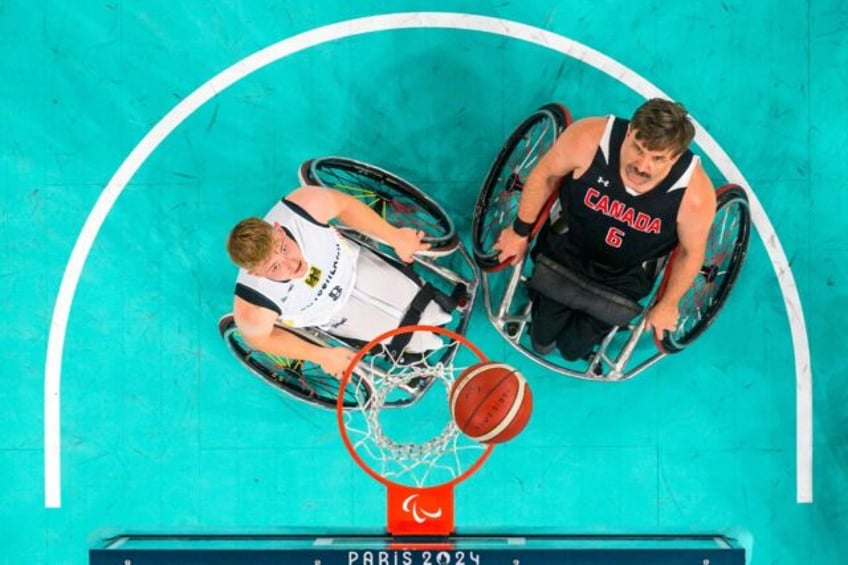 Canada's Robert Hedges competes for the ball with Tobias Hell of Germany -- the Canadians