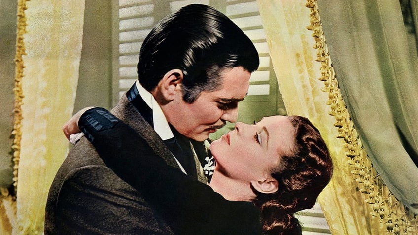 Clark Gable and Vivien Leigh embracing for a kiss in Gone with the wind