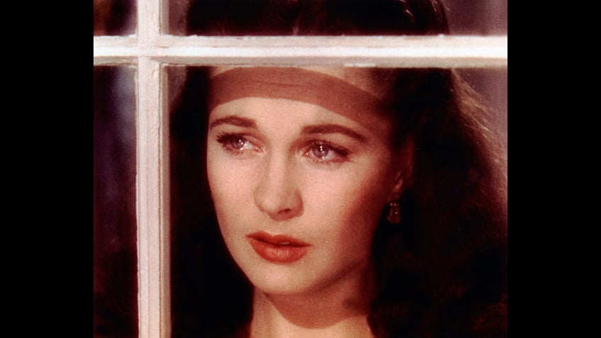 a close-up of Vivien Leigh looking out a window and crying.