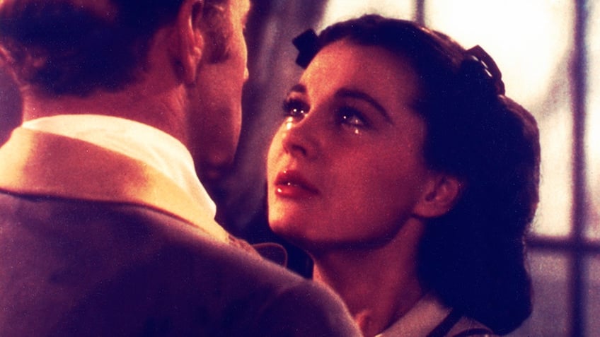 a close-up of Vivien Leigh crying looking up at a man.