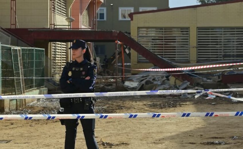 A police officer stands in front of Luis Vives college of Massanassa, south of Valencia, o